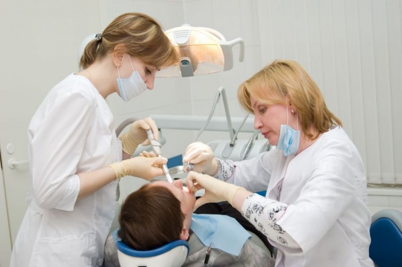 Dental Assistant assisting a Dentist