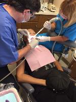 Dentist and Dental Assistant with Patient