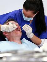 Dental Hygienist using instruments